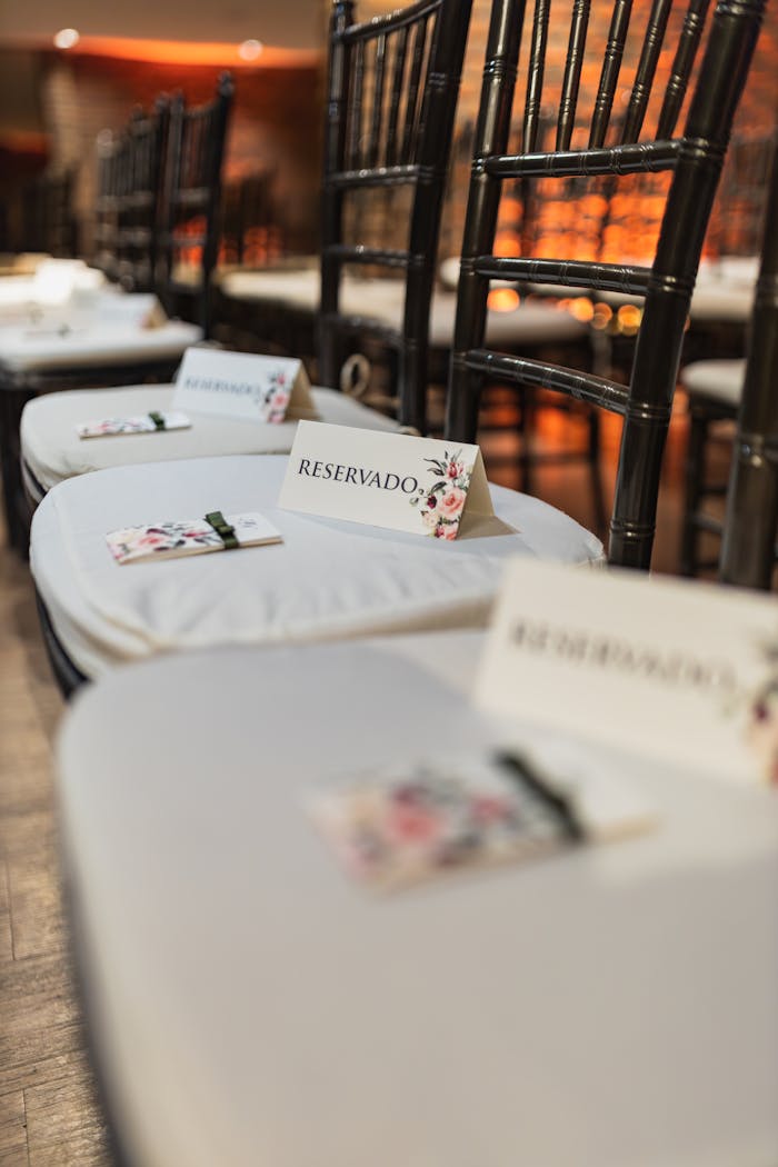 Charming close-up of reserved wedding seats with floral decor, perfect for elegant event settings.